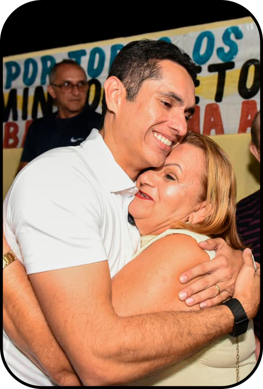 Domingos Neto abraçando eleitora em evento de campanha